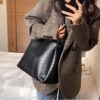 Woman carrying umber black shoulder bag for daily use